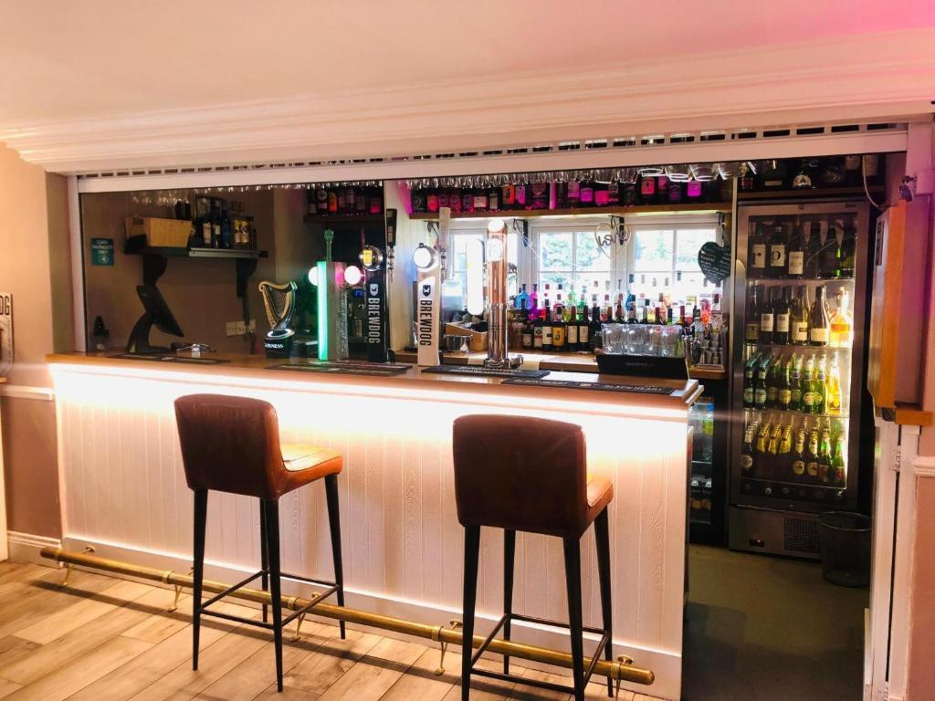 The bar at Sheene Mill with high stools and warm lighting