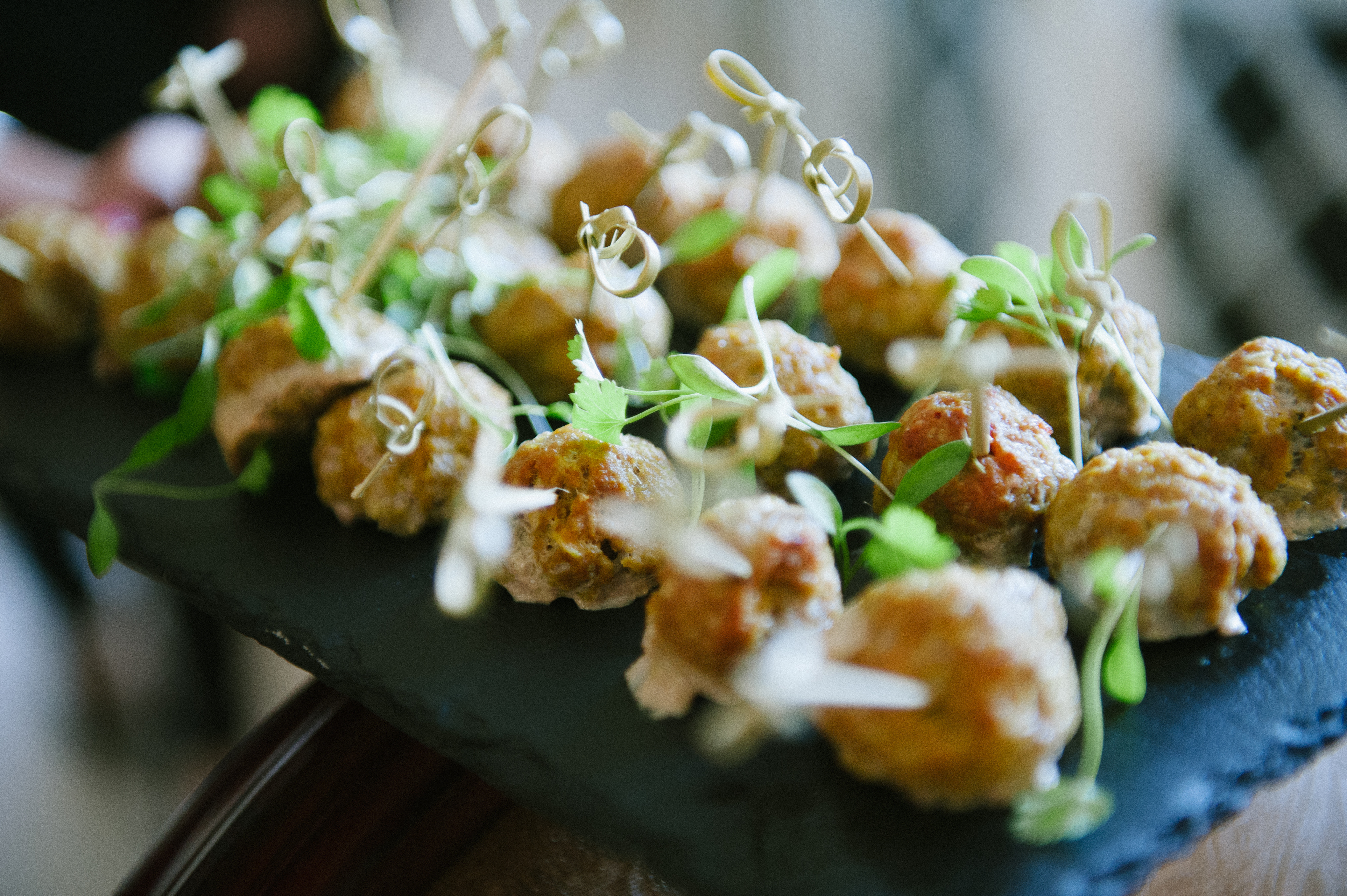 Canapé bites on knotted bamboo picks with micro herbs, served on slate at an event at Sheene Mill, Cambridgeshire