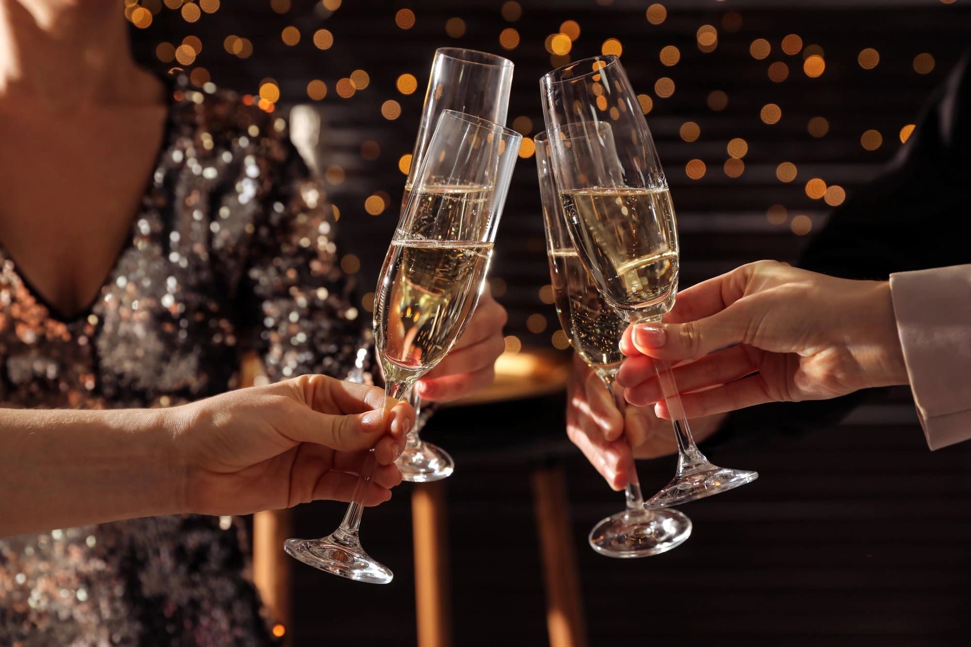 Guests raising a toast with champagne flutes at a Christmas party at Sheene Mill, Melbourn, Cambridgeshire