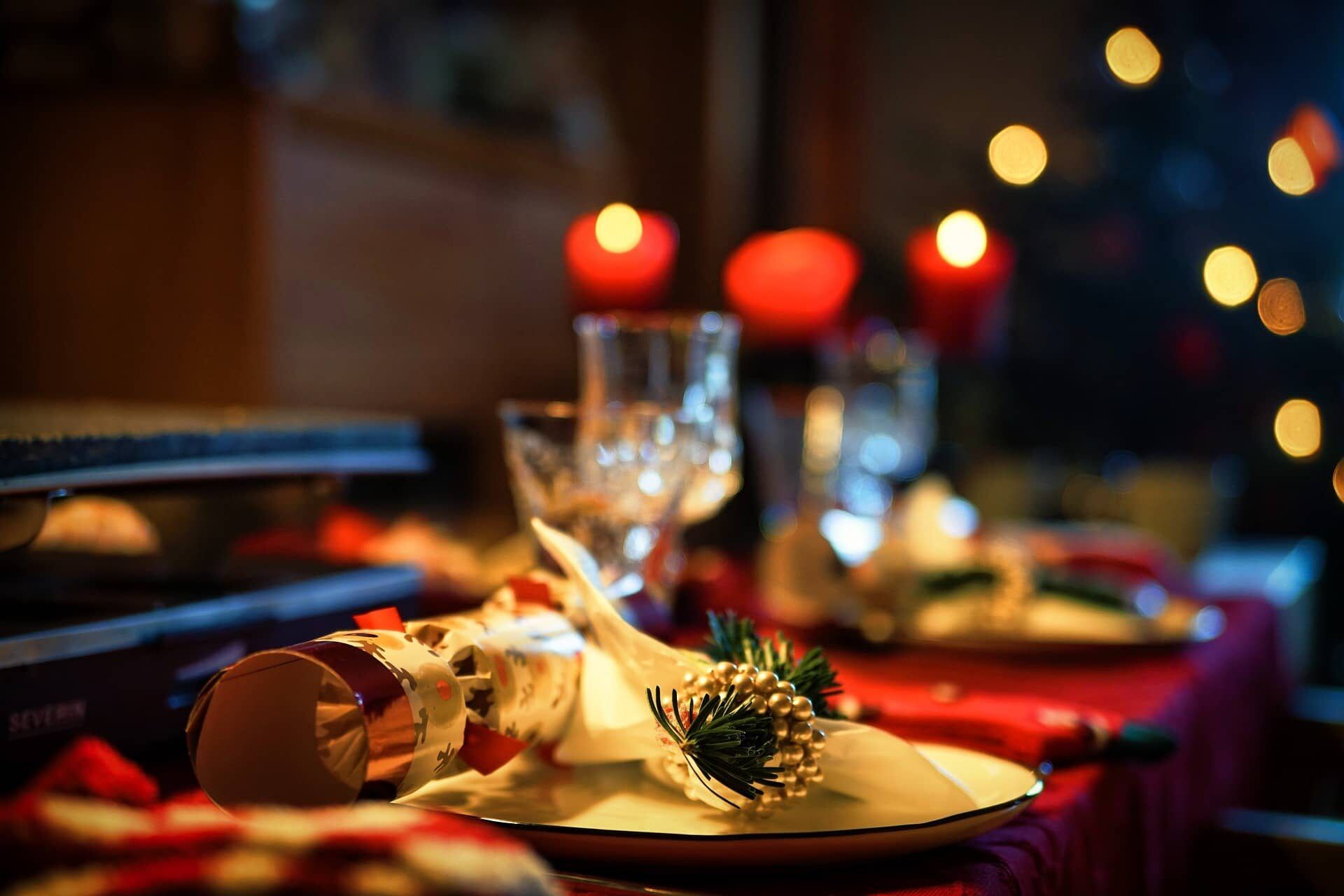A Christmas table setting with crackers, candles and festive decorations at Sheene Mill, Cambridgeshire