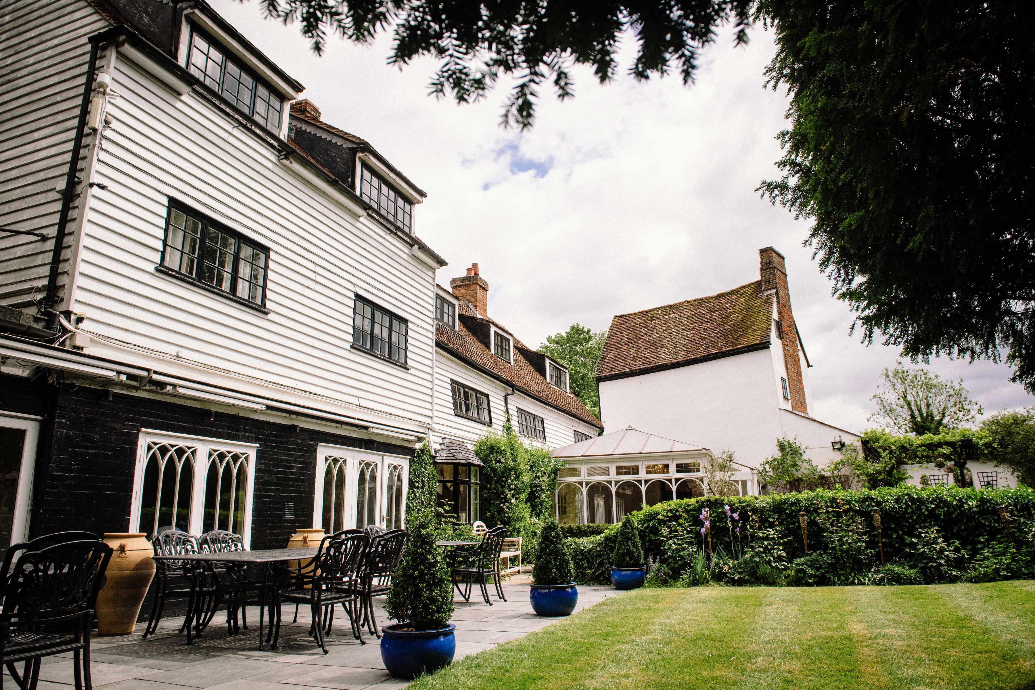 The white clapboard mill house and terrace seating at Sheene Mill, Melbourn