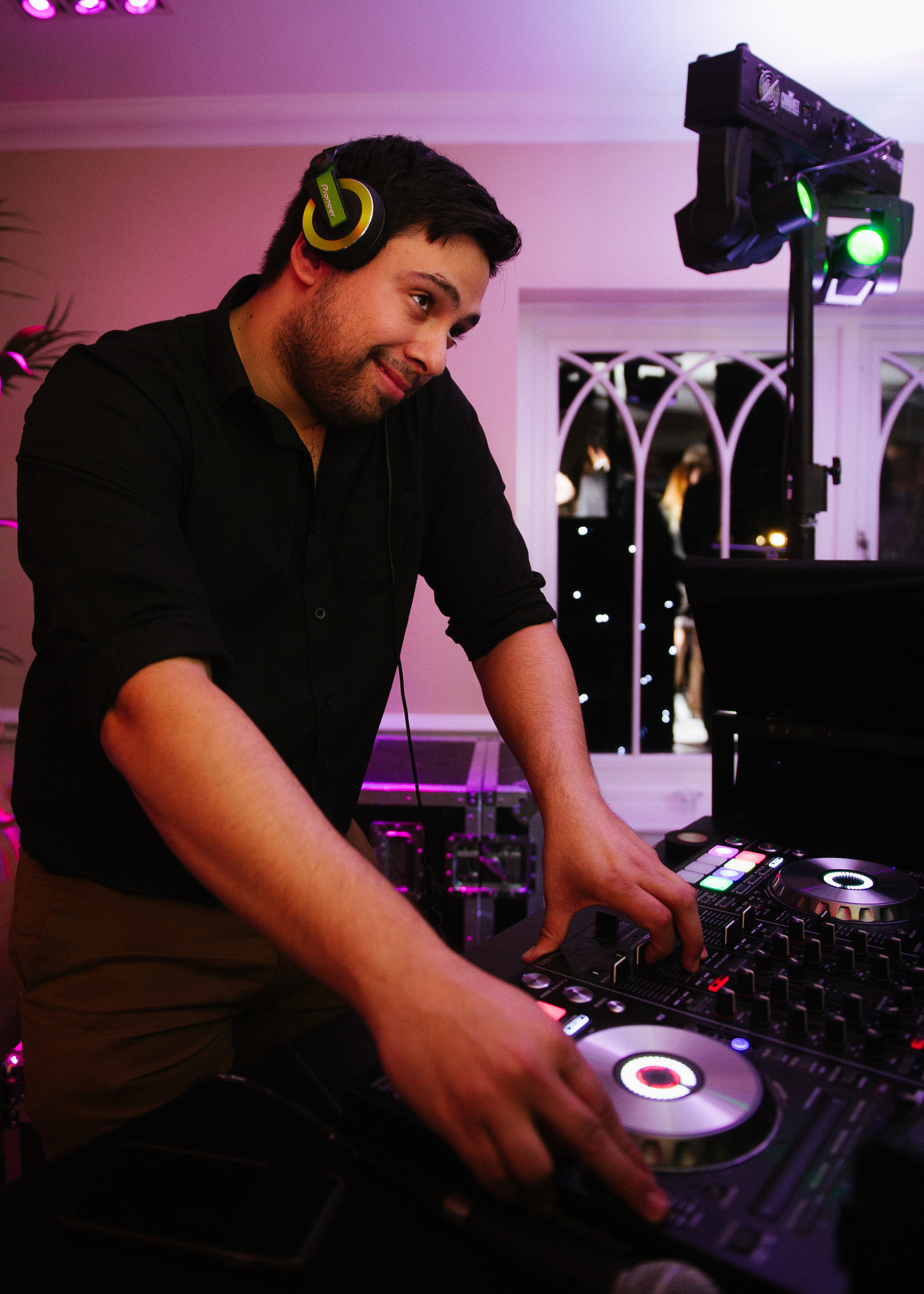 A DJ mixing at an evening celebration at Sheene Mill